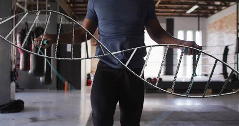 Man jumping rope with dna overlay in urban gym setting