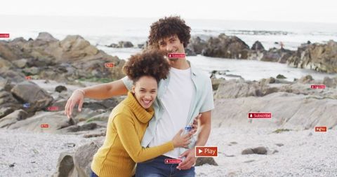 Smiling Couple Embracing on Rocky Seaside