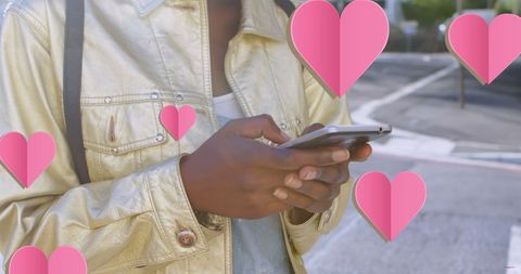 Woman in Metallic Jacket Texting with Floating Hearts