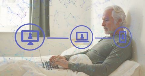 Senior Man Using Laptop in Bedroom with Digital Connections Overlay