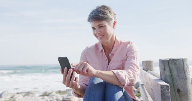 Smiling Woman Using Smartphone by Ocean - Download Free Stock Images Pikwizard.com