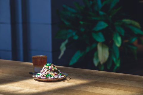 Colorful Healthy Salad with Glass of Iced Tea on Wooden Table in Moody Natural Light