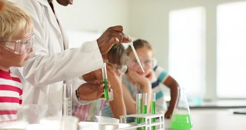African American Teacher Demonstrating Green Chemistry Experiment with Curious Students