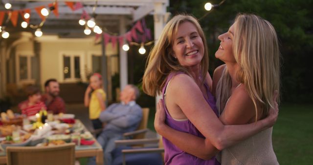 Joyful Bonding of Mother and Daughter at Outdoor Family Gathering - Download Free Stock Images Pikwizard.com