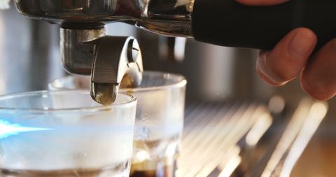 Close-Up of Espresso Pouring into Glass with Pro Barista Handling - Download Free Stock Images Pikwizard.com