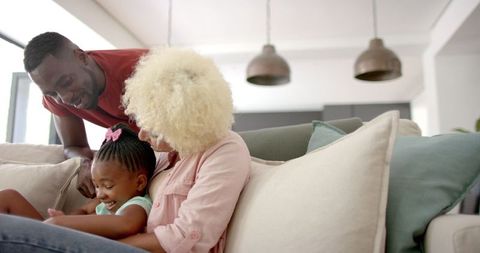 Diverse Family Engaging on Couch with Tablet Technology