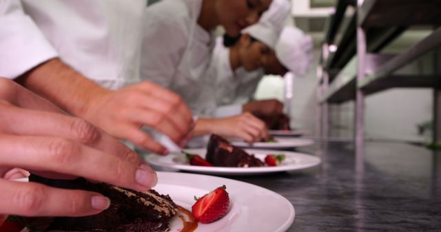 Chefs Decorating Chocolate Desserts with Strawberries in Kitchen - Download Free Stock Images Pikwizard.com
