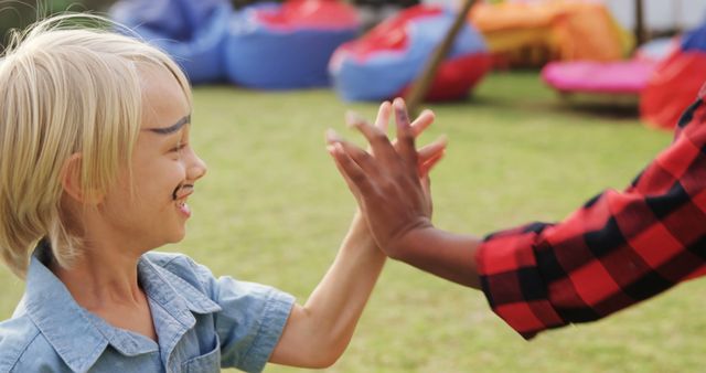 Children High-Fiving Outdoors During Playtime - Download Free Stock Images Pikwizard.com