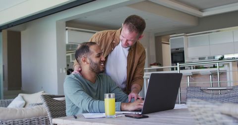 Multi-ethnic gay couple enjoying quality time at home