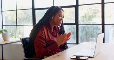Businesswoman in Virtual Meeting at Office Desk