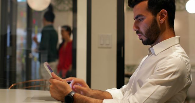 Focused Man Working on Digital Tablet in Office Environment - Download Free Stock Images Pikwizard.com