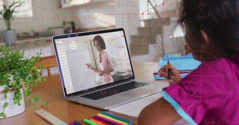 Child Engaged in Online Math Lesson from Home with Laptop