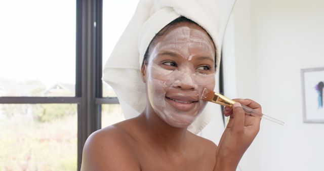 Young African American Woman Applying Facial Mask for Skincare - Download Free Stock Images Pikwizard.com