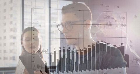 Colleagues Collaborating on Digital Data Analysis in Modern Office