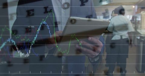 Businessman Analyzing Data on Tablet in Modern Workspace