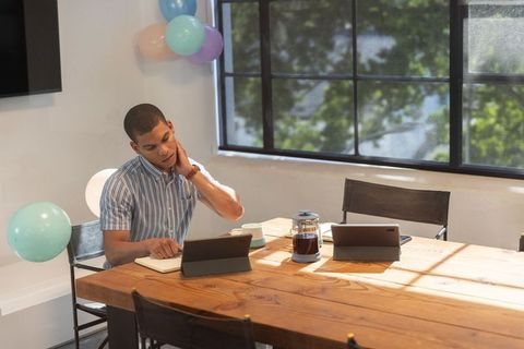 Young man working in modern office co-working space during celebration