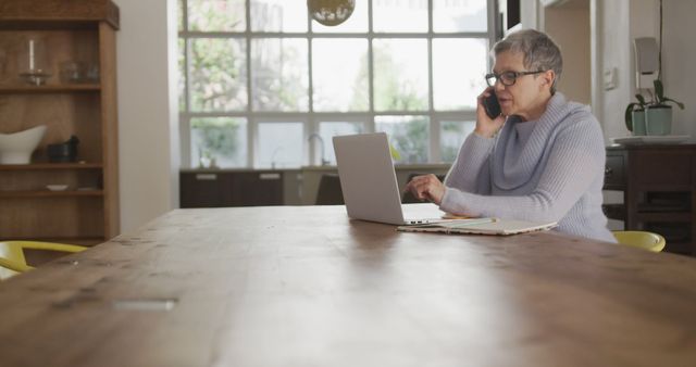 Senior Woman Working from Home Using Laptop and Phone - Download Free Stock Images Pikwizard.com