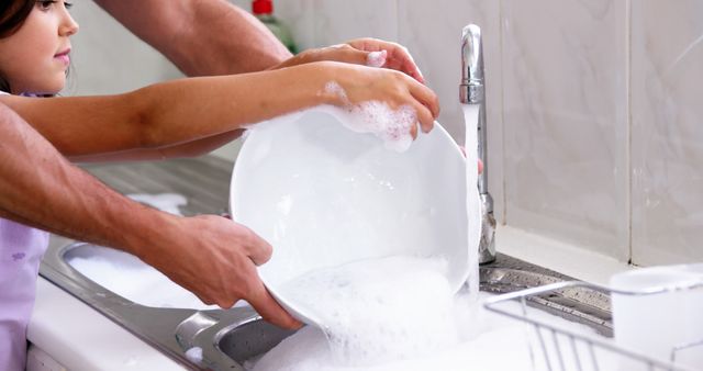 Parent and Child Washing Dishes Together in Kitchen Sink - Download Free Stock Images Pikwizard.com