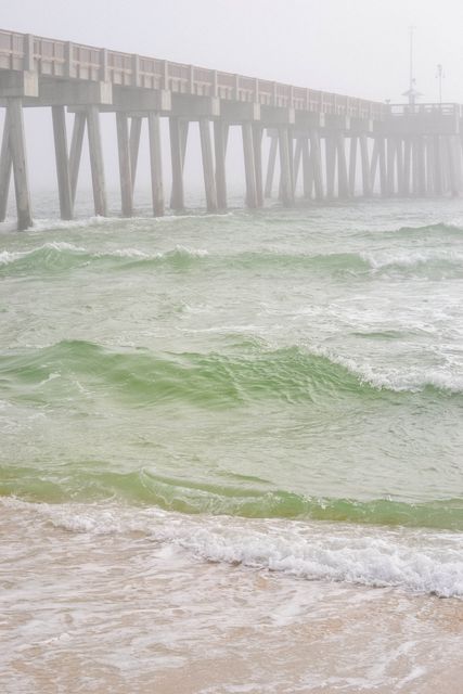 Serene Ocean Waves Under Rustic Pier on Misty Day - Download Free Stock Images Pikwizard.com