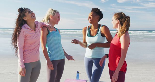Happy group of diverse female friends having fun at the beach. holiday, freedom and leisure time outdoors.