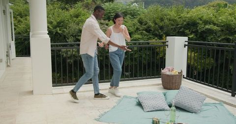Smiling couple enjoy exclusive balcony moments surrounded by nature