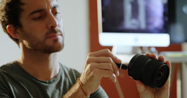 Photographer Cleaning Camera Lens in Modern Office - Download Free Stock Images Pikwizard.com