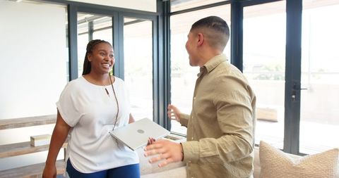 Diverse Team Sharing a Joyful Moment in Bright Office Space