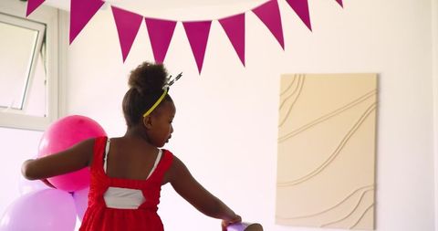 Man hanging pink bunting in cheerful decor atmosphere