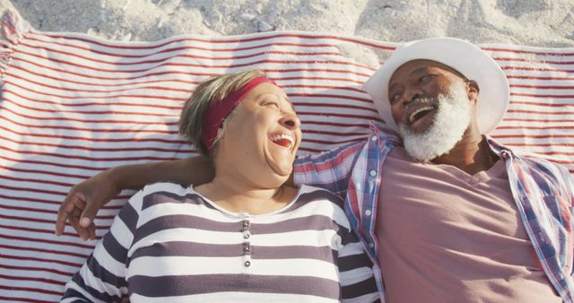 Smiling Senior Couple Relaxing on Beach Blanket - Download Free Stock Images Pikwizard.com