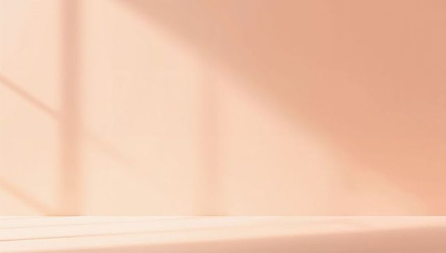 Warm peach minimal interior with diagonal window shadows and low display platform