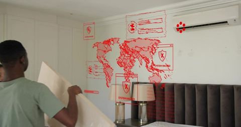 Man installing wall panel in bedroom with holographic 'system hacked' cyber projection