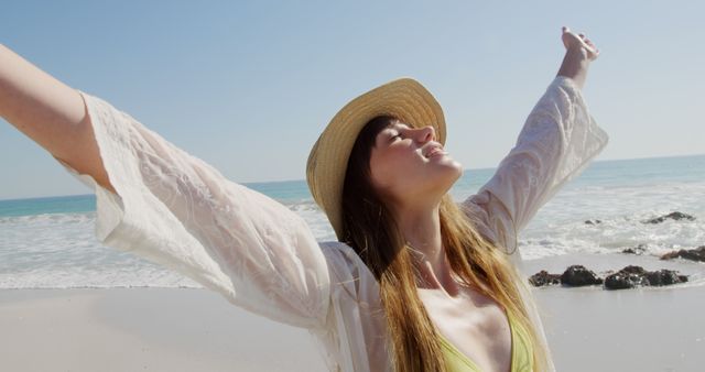 Young Woman Enjoying Beach Day with Open Arms in Sunlight - Download Free Stock Images Pikwizard.com