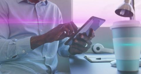 Focused Professional Engaging with Tablet in Modern Workspace