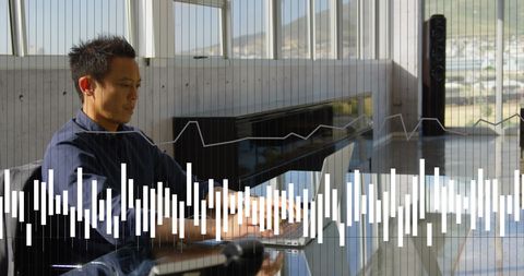 Asian businessman analyzing financial data on laptop in modern office