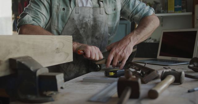 Carpenter Working with Wood in Workshop with Tools on Desk - Download Free Stock Images Pikwizard.com