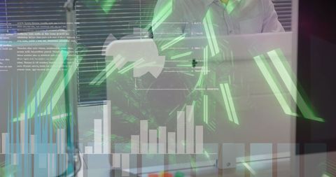 Professional Analyzing Financial Data on Laptop with Graphs Overlay