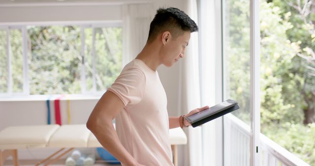 Young Man Reading a Book by the Window - Download Free Stock Images Pikwizard.com