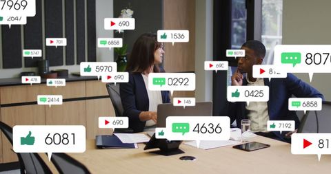 Diverse Coworkers Collaborate Amid Social Media Notifications