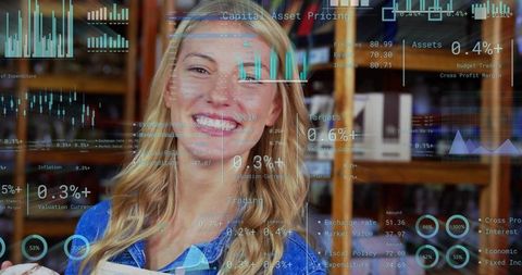 Smiling young woman holding book in library with finance data overlays and graphs