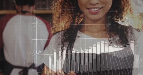 Smiling barista reading digital analytics in trendy cafe