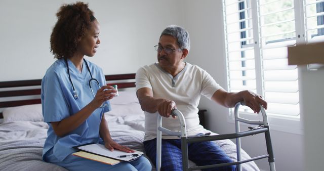 Nurse providing assistance to elderly patient with walker, engaging in conversation within home setting. Ideal for illustrating home healthcare services, elder care, patient support, nursing jobs, and senior living solutions.