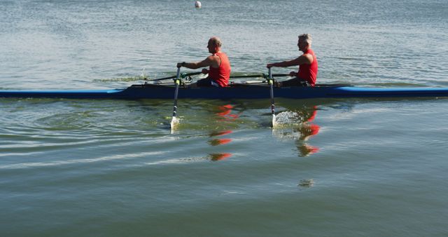 Two senior caucasian men rowing boat on a river - Download Free Stock Photos Pikwizard.com