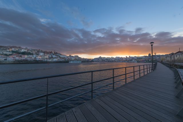 Riverside Walkway in Porto at Sunset with Dramatic Sky - Download Free Stock Photos Pikwizard.com