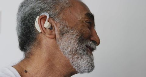 Senior Man with Hearing Aid Smiling