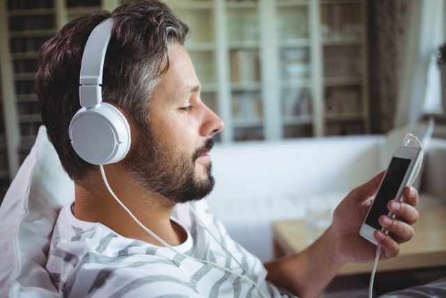 Man Relaxing at Home Listening to Music on Headphones - Download Free Stock Photos Pikwizard.com