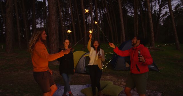 Group of Friends Celebrating with Sparklers at Nighttime Campground - Download Free Stock Images Pikwizard.com