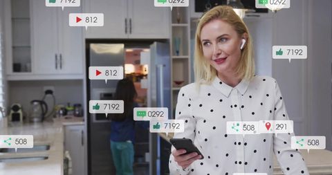 Woman Engaging with Social Media Notifications in Kitchen
