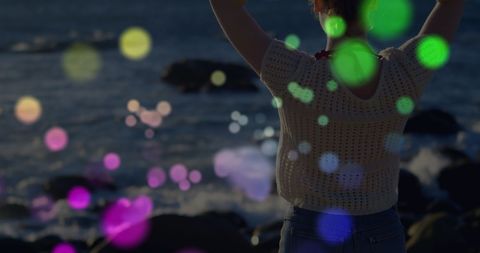 Woman Enjoying Sea View with Colorful Bokeh Overlay