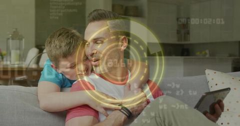 Father and son bonding over tablet with fitness tracker and augmented reality hud