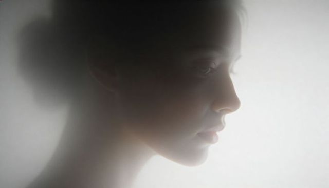Ethereal female profile in soft haze backlight minimalist portrait with glowing rim light